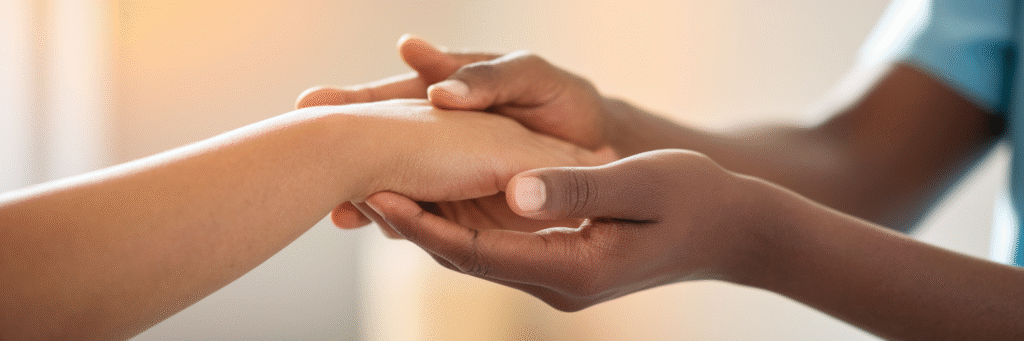 Supportive hands during a medical consultation.