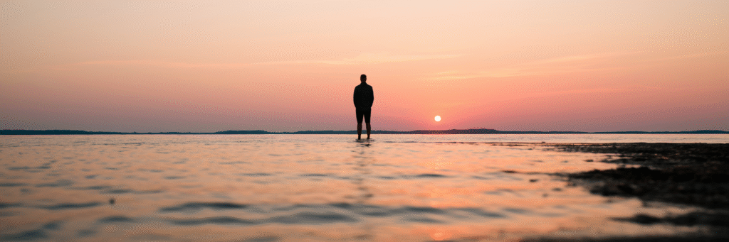 Person watching sunrise over Chesapeake Bay.