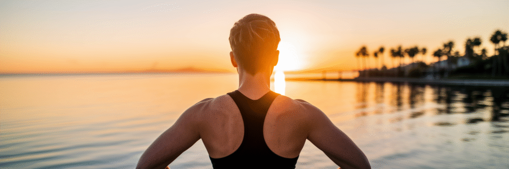 Person watching a Florida sunrise over water.