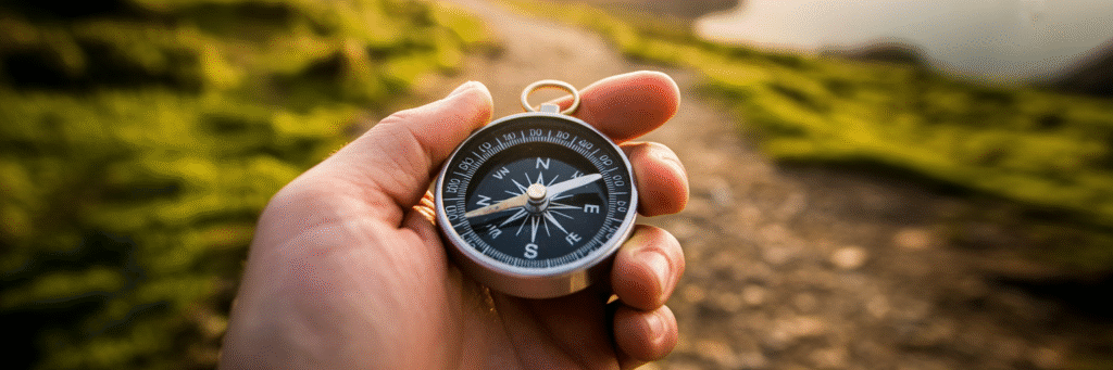 Compass pointing forward in hands.