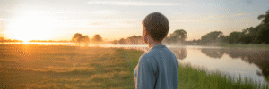 Person watching sunrise over Florida lake.