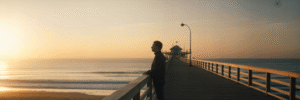 Person at Virginia Beach pier at sunrise.